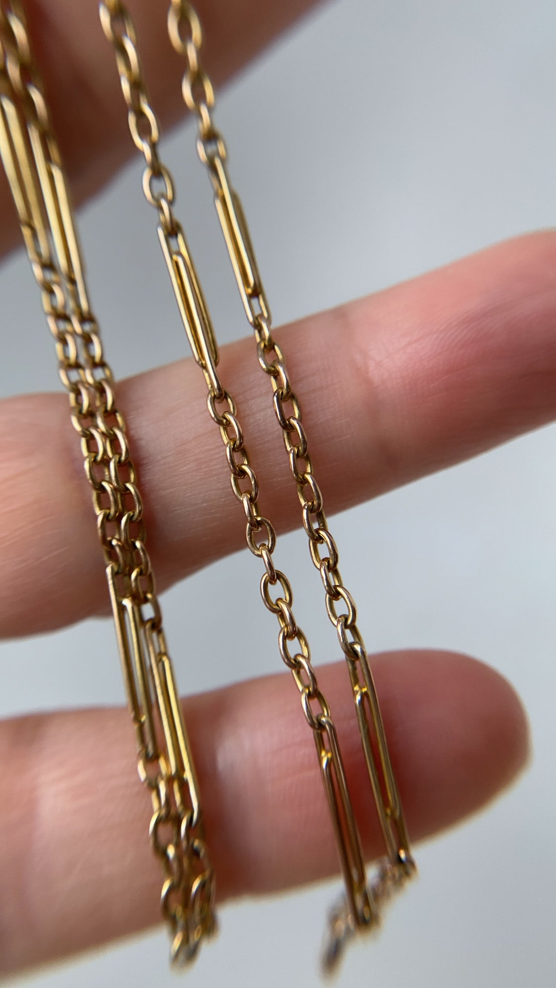 antique baby trombone and cable link chain