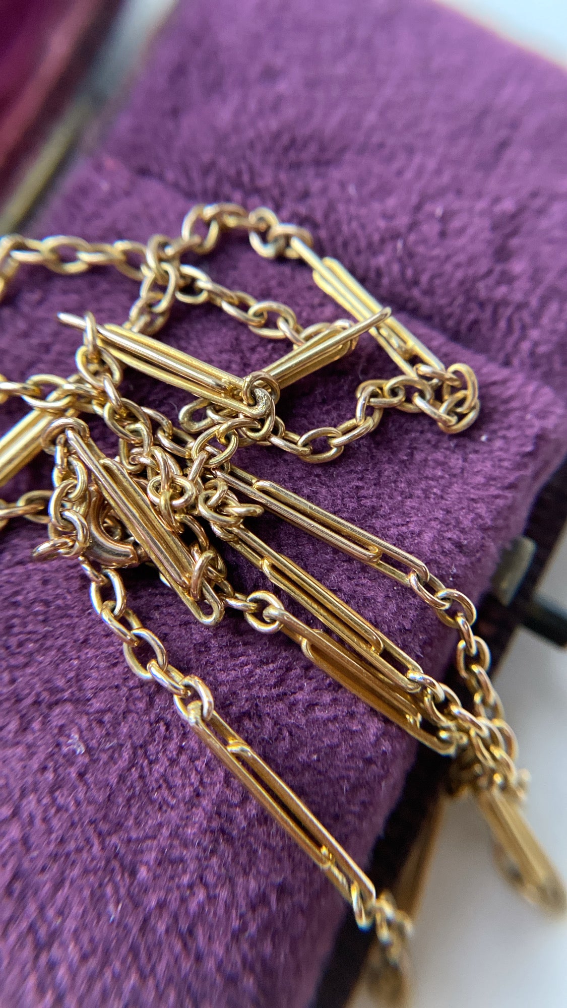 antique baby trombone and cable link chain